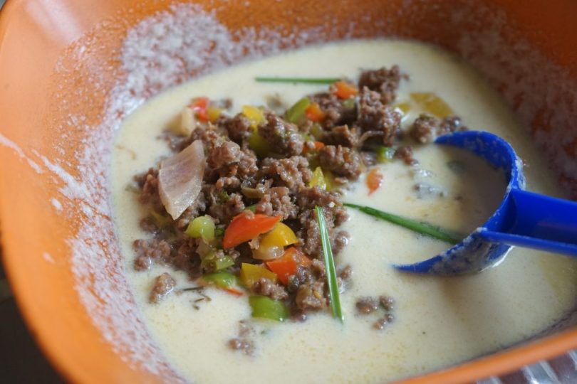 Here are some alternative title rewrites:

Classic Semolina Pancakes with Savory Ground Meat
or
Homemade Meat-Stuffed Semolina Pancakes

The second version is particularly effective as it:
- Clearly states the dish name
- Uses "homemade" to appeal to those seeking authentic recipes
- Accurately describes the combination of ingredients
- Is concise yet informative
- Maintains professional tone